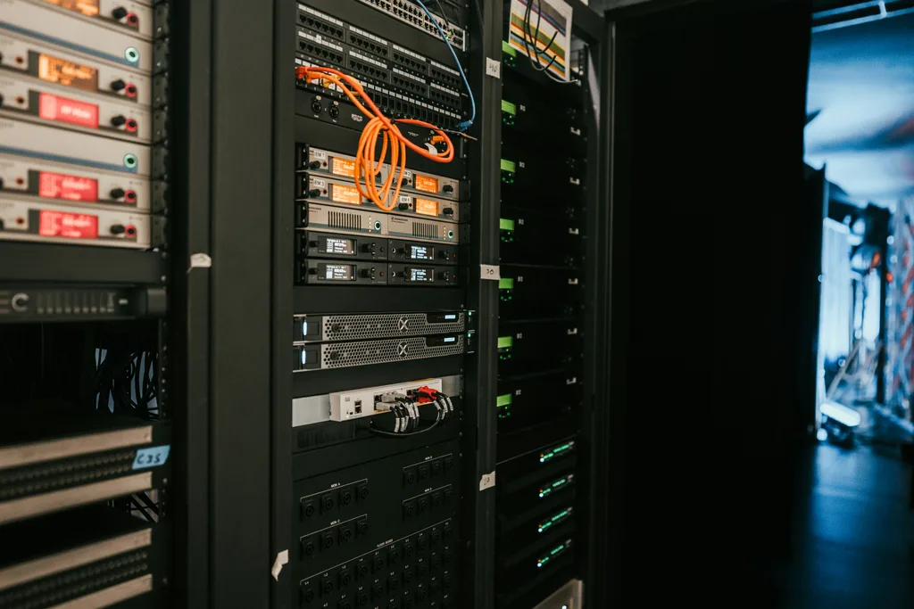 Data centre technician working on server rack installation